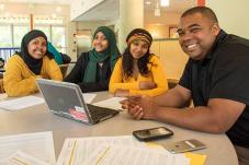 Ty Edwards youth engagement specialist at table with three teen girls