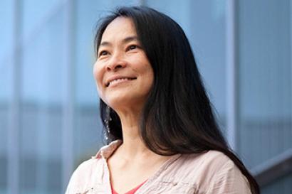 Woman standing in front of building.