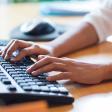 Person typing on keyboard