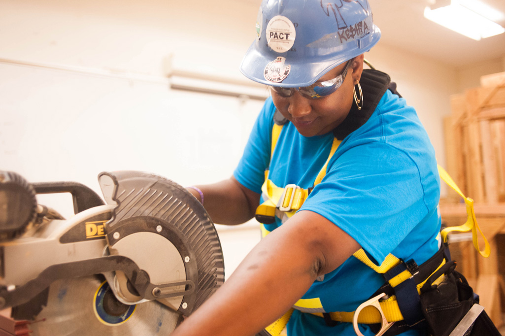 Woman in construction gear working with power tool