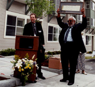 Al Levine, Deputy Executive Director, presents Harry Thomas with the house number from the Holly Park house where he once lived.
