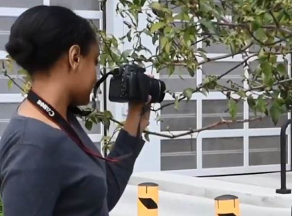 Young filmmaker holding camera